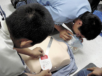 As part of a First Aid course, two participants in the Alliquujattiavait Kivalliq “Gems” program learn how to defibrillate on a mannequin.