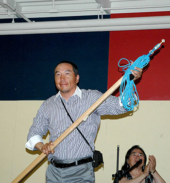 Lukasi Piluruut of Kangiqsujuaq receives a seal harpoon from this year's hunt crew in recognition of the role he played as head harpooner in Nunavik's second successful bowhead whale hunt. (PHOTO BY SARAH ROGERS)