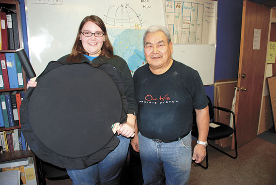 Caitlin Little with her finished drum. With her is David Serkoak, an instructor at Nunavut Sivuniksavut, who taught her how to make the drum.