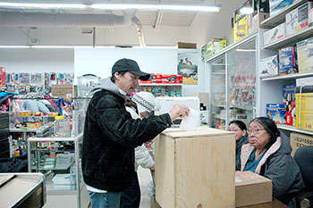 Voters in Kangiqsujuaq cast ballots in the Nov. 4 municipal election at a polling station set up in the local co-op store. (PHOTO BY SARAH ROGERS)