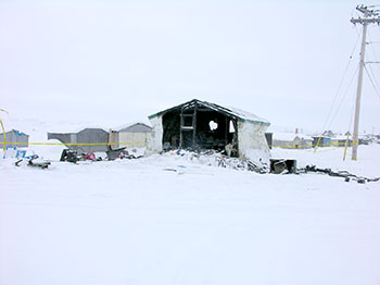A Iqaluit man, Richard Doucet, 32, suffered severe injuries in a Feb. 19 fire that gutted this old matchbox house that's been converted into a shack on the beach. His 19-year-old girlfriend now faces one count of arson.