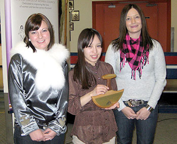 Speaking out: the Qulliit Nunavut Status of Women Council last year honoured Levi Nowdlak, 18, with their Wise Woman of the Year award for her confronting her sexual abuser and sharing her story publicly. Qulliit’s vice-president, Trista Mercer (left), and executive director Shylah Elliott pose with Nowdlak after presenting the award. This year, however, council members fear retribution from employers, including the GN and NTI, if they speak out about issues affecting women. (FILE PHOTO)