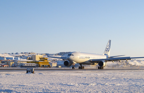An Airbus prototype cargo jet touches down at Iqaluit's airport in January, 2010. The airport's iconic yellow terminal building, seen in the background, could soon be replaced by a new $40-million terminal big enough to handle booming passenger volumes. (PHOTO BY CHRIS WINDEYER)