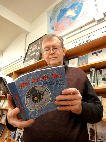 Thumbing his favourite book, <I><p class=