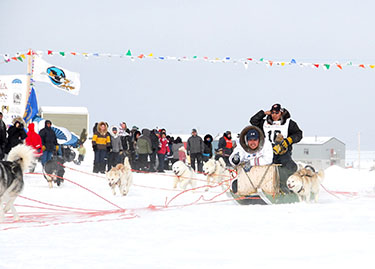 Billie and Willie Cain Jr. from Tasiujaq launch their dog team in Quaqtaq at the March 22 start of Ivakkak 2010. (PHOTO BY PIERRE DUNNIGAN)