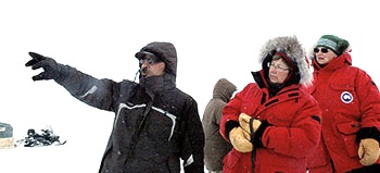 Guide Yaaka M. Jaaka points out landmarks along Wakeham Bay to Nicole Ménard, Quebec’s minister for tourism, far right, and deputy minister Suzanne Giguère. (PHOTO BY SARAH ROGERS)