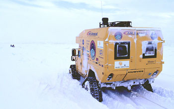 Moon-1 struggles through deep snow as it follows its snowmobiling guides across the sea ice.