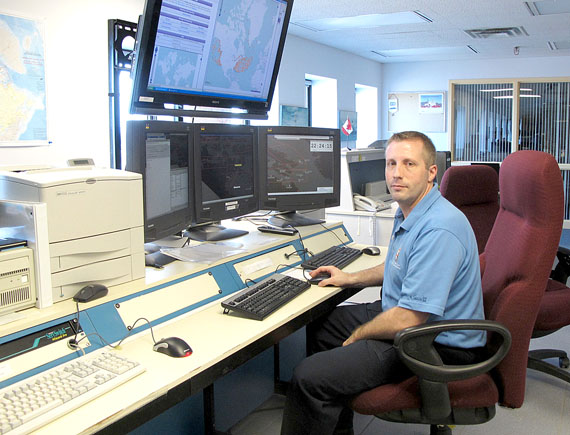 Marine communications and traffic services officer Louis Robert keeps an eye on all large ships passing through Canada’s Arctic waters. (PHOTO BY GABRIEL ZÁRATE)