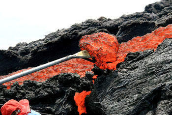 The bronze mold will only last a few minutes of contact with the glowing red-hot molten lava before it melts into destruction, so quick work is essential.