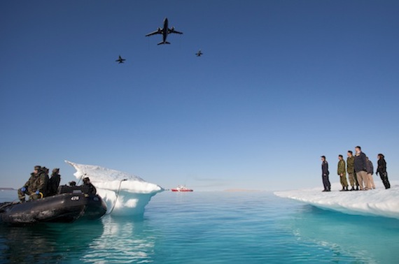 Prime Minister Stephen Harper watches as a pair of CF-18 Hornets and a CC-150 Polaris fly past during Operation Nanook. (PHOTO BY JASON RANSOM/ PMO)