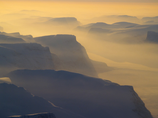 The rugged terrain between Clyde River and Pond Inlet is seen at dusk in this April, 2009 file photo. Searchers believe a helicopter pilot who went missing in the area this week could not have survived the crash. (PHOTO BY CHRIS WINDEYER)