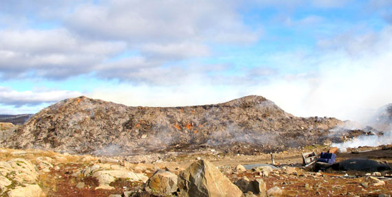 A crust of ash caps the smoldering construction debris pile at the Iqaluit landfill on Sept. 26. The Iqaluit fire department is unable to extinguish the fire and is now only able to contain it. (PHOTO BY GABRIEL ZÁRATE)