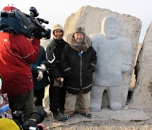 Carver Simeonie Amagoalik, right, stands beside his year-long labour: a monument to the High Arctic Exiles who founded Resolute. A plaque reads in English and Inuktitut,