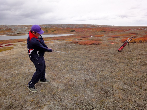 This Kuujjuaq golfer concentrates on hitting his golf ball as close to one of the course's eight holes as possible during a Sept. 18 tournament which drew many of the Nunavik community's keen golfers. (PHOTO BY JANE GEORGE)