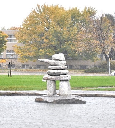A lone inuksuk watches out over the rainy campus at Cégep Marie-Victorin in Montreal’s north-east end. (PHOTO BY SARAH ROGERS)