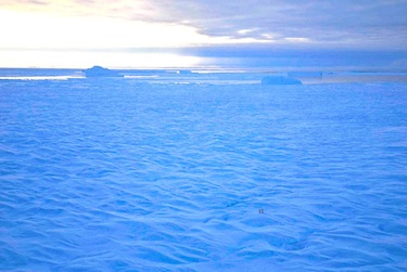 This aerial photo taken Oct. 18 of two scientists deploying a satellite beacon on an ice island (seen a pair of tiny dots near the bottom right) shows the immensity of these ice islands which are now heading south from Ellesmere Island towards Baffin Bay. (PHOTO BY RENE HARDY/ARCTICNET)