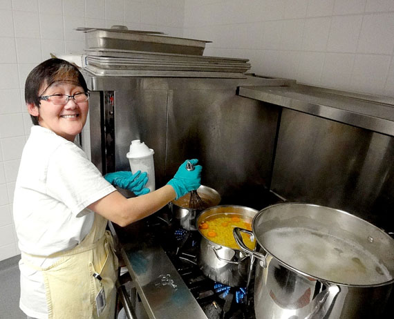 Country foods and good, homemade hot meals are always on the menu at Larga Kitikmeot. Here, cook Sarah Narlungaq prepares soup for an evening meal.(PHOTO BY JANE GEORGE)