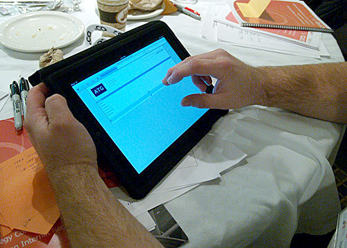 An iPad owner uses his prized tablet computer during a break at a forum on internet issues organized by the Canadian Internet Registration Authority in Iqaluit Nov. 15. Iqalummiut weighed in on Northern internet issues, including cost, access and the growing need for bandwidth North of 60. (PHOTO BY CHRIS WINDEYER)