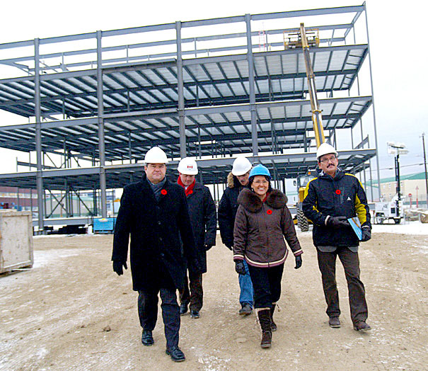 Nunavut MP Leona Aglukkaq, centre, tours the construction site Inuksugait Plaza phase 4 in Iqaluit Nov. 10. Aglukkaq announced the signing of a 10-year lease that will see the headquarters of the Canadian Northern Development Agency move into the building once it's completed in 2011. (PHOTO BY CHRIS WINDEYER)