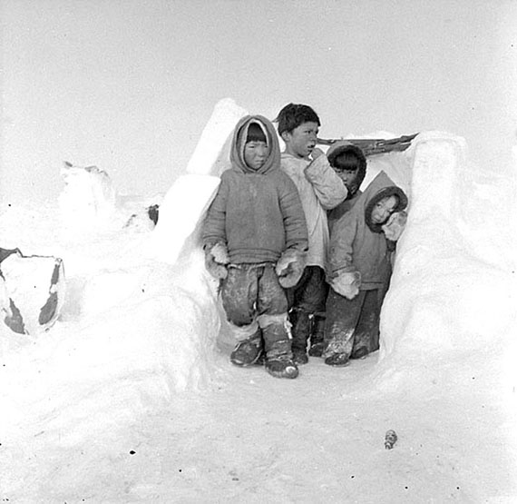 Jose Kusugak, aged three (last on the right), at the entrance to a qammaq located in Repulse Bay, his birthplace, in 1953. On Jose’s right stands his brother, Michael Kusugak, with Yvo Airut and Paul Manittuq. (PHOTO BY J.C. JACKSON, LIBRARY AND ARCHIVES CANADA PA-102697)