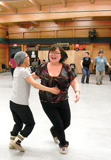 Margo and Natasha Nedlak swing around Feb. 23 during the weekly square-dancing practice in Cambridge Bay. (PHOTO BY JANE GEORGE)