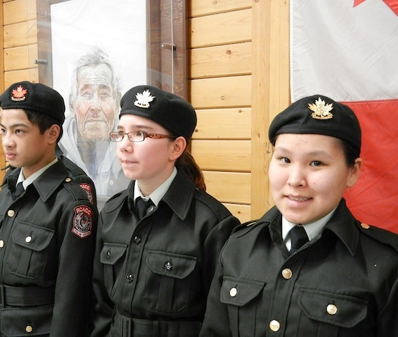 During a Feb. 13 evening event at Cambridge Bay's Luke Novoligak community centre to honour cadets, Daniel Calamayan, Skye Corey and Donna Lyall from the 3004 Nanook Royal Canadian Army Cadet Corps of Cambridge Bay stand in front of a photo of the late Luke Novoligak, who passed away in 2005 (PHOTO BY JANE GEORGE).