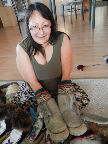 Julia Ogina shows a pair of warm sealskin kamiks that her grandmother Taipana in Uluhaktok made for her. (PHOTO BY JANE GEORGE)