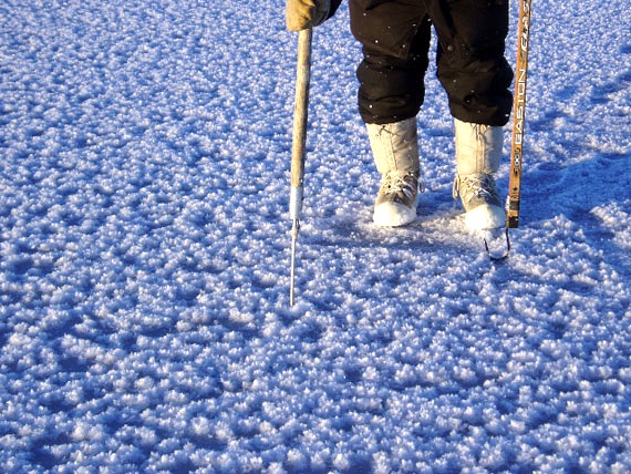 Theo Ikummaq tests the thickness of the new ice near a polynya just outside Igloolik in Nov. 2004. According to the Siku atlas, a polynya is an area of water that never freezes which is surrounded by sea ice. (PHOTO BY GITA LAIDLER)