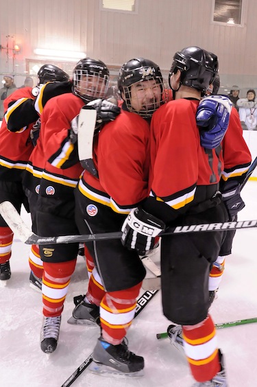 Kangiqsujuaq’s Flames celebrate after scoring another goal. (PHOTO BY PASCAL POULIN)

