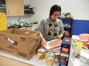 Tiffany Otokiak puts away food at Cambridge Bay's youth centre which kids will help cook and later eat, as part of a daily cooking class and supper program. (PHOTO BY JANE GEORGE)
