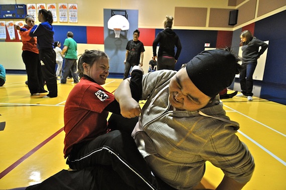 Kangiqsuallujjuaq student Ella Annanack shows Chatham-Kent student Missy Batten the arm pull during an Inuit games demonstration at the Kangiqsualujjuaq community centre last month. The two students participated in a Nunavik-Ontario student exchange this past February and March. (PHOTO BY GILLIAN WARNER)