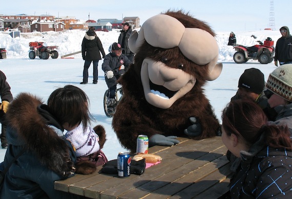Ollie the Omingmak sits with some young friends on May 21 during Cambridge Bay's Omingmak Frolics. The week-long festival wraps up May 23.