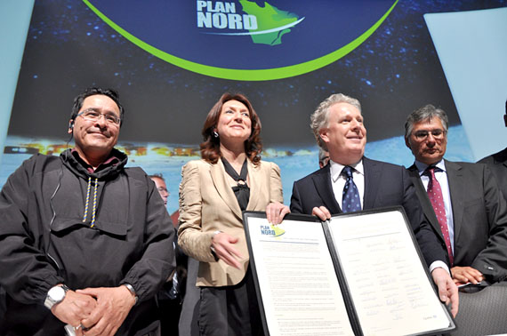 Pita Aatami, the president of Makivik Corp. (left), poses with Quebec cabinet minister Nathalie Normandeau and Quebec premier Jean Charest alongside other northern leaders at the May 9 launch  in Lévis, Que. of the province's 25-year blueprint for the North. (PHOTO BY DAVID BENOIT)