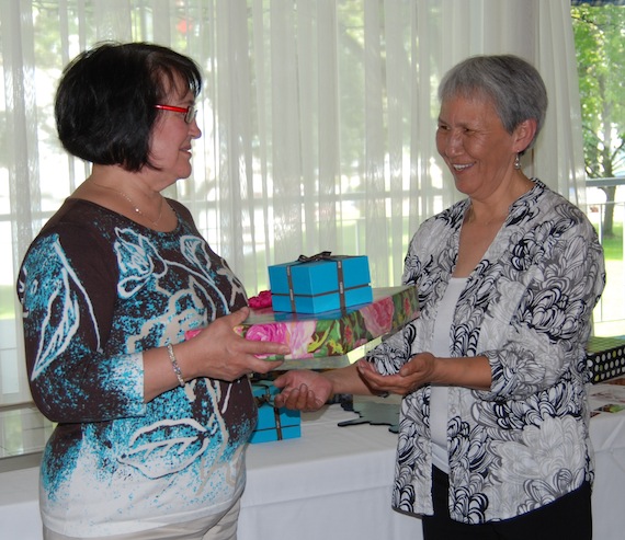 Annie Grenier, who is retiring as director general of the Kativik School Board, accepts a gift from KSB president Alacie Nalukturuk June 21 in Montreal. (PHOTO COURTESY OF THE KSB)