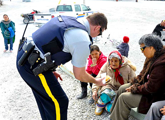 June 21 was barbecue time in Hall Beach, where Cpl. David Ferguson and Cst. Mitchell Perry cooked and dished out 144 hotdogs, 230 hamburgers and 40 litres of juice with the help of their families and Canadian Ranger Leetia Siakuluk. Ammittuq MLA Louis Tapardjuk cut the special National Aboriginal Day cake. A similar barbecue in Cambridge Bay, held with the assistance of the community justice branch, the Hamlet of Cambridge Bay and the wellness center, saw hot dogs, hamburgers, muskox burgers and muskox sausages served to 250 community members. (PHOTO COURTESY OF THE RCMP)