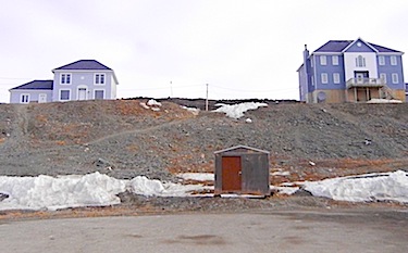 These houses in Kangirsuk, two of the 60 privately-owned homes in Nunavik, were built during the first round of home ownership programs in Quebec. (PHOTO BY JANE GEORGE)
