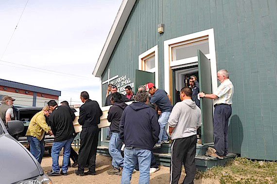 Family and friends of Sylvain Degrasse load his casket into a hearse outside of Iqaluit’s Our Lady of Assumption Catholic church, where a funeral mass was held June 28. Degrasse, 44 was found dead in the Iqaluit cemetery June 7 with a rifle across his chest. (PHOTO BY SARAH ROGERS)