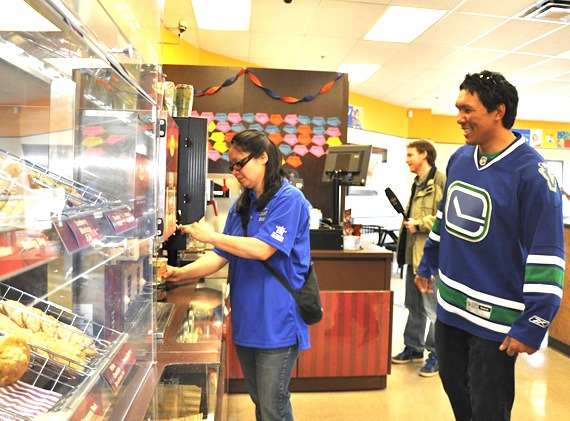 Iqaluit mayor Madeleine Redfern, left, serves up coffee to local Tim Horton's customers during the franchise's Camp Day June 1. The coffee chain plans to donate  the money it makes on coffee sales June 1 to the Tim Horton's Children's Foundation, which sends 14,000 children in Canada and the United States to its six summer camps. This year, two children from Nunavut be invited to participate in a 10-day camp. (PHOTO BY SARAH ROGERS)