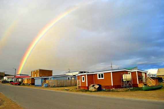 A magnificent rainbow, produced by rays of light from the setting sun passing through droplets of water in the atmosphere, soars across the northeast corner of the sky above Iqaluit July 21 at about 8:45 p.m. A second rainbow arc, also visible in this picture, is produced by light reflected twice by water droplets, and displays the colours of the visible spectrum in reverse order. In many of the world's cultures, rainbows are imagined as pathways between Earth and Heaven. (PHOTO BY JIM BELL)