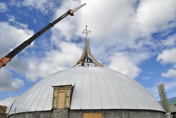 Workers use a large crane to hoist a four-tonne spire atop the new St. Jude's Cathedral in Iqaluit July 21. The spire, which bears a large cross, was manufactured at Triodetic Ltd. in Ottawa and shipped to Iqaluit via sealift. (PHOTO BY JIM BELL)