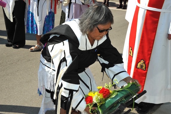 Sally Webster, daughter of the late RCMP special constable Andrew Ooyoumut, lays a wreath at the Memorial Wall of the RCMP in Regina during a Sept. 11 ceremony which saw Ooyoumut's added name to the RCMP Honour Roll, Memorial Wall and Cenotaph, which honour members who lost their lives while performing policing duties. Ooyoumut, who once walked through a blizzard to bring food to starving families, was in his late 30s when he drowned July 21, 1954, in the Kikatavyuk River near Baker Lake while helping to catch fish for RCMP sled dogs. Webster and her sisters, Lucy Evo and Janet Tagoona, and her daughter, Deborah Kigjugalik Webster, attended the Sept. 11 ceremony dressed in pukiliks made by Ooyoumut's late wife. (PHOTO BY CHRISTINE ROSS/ RCMP-GRC)