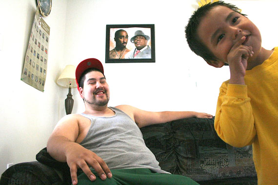 Serge Lampron is shown here with one of his two sons. A photo of of his two rap idols is in the background, The Notorious B.I.G. and Tupac Shakur. (PHOTO BY JUSTIN NOBEL)