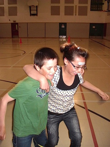 Shona McCusker, a former Kangiqsujauq school principal, led three-legged races during the Proud Reunions camp last month. (PHOTO COURTESY OF PROUD REUNIONS)