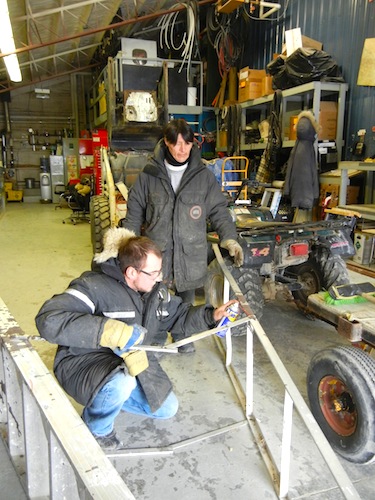 Adlair workers Willie Oakoak and Gordon Greene could be out of a job at the end of the month, but an Oct. 3 visit found them fixing a ladder they may need later this year. (PHOTO BY JANE GEORGE)