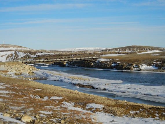 Supports for this bridge leading towards Mount Pelly near Cambridge Bay were dangerously eroded this past June when torrents of melt water reached the level of the bridge. Now a wider, longer, second-hand bridge from Pangnirtung has arrived in Cambridge Bay as a replacement for the bridge shown here. Ironically, Pangnirtung's bridge was also the casualty of extreme weather in 2008, when heavy rains and melt water saw the Duval River carve a new course and wash away the earth that supported two bridges in town. Pangnirtung's bridge has already arrived in Cambridge Bay, but the hamlet is waiting on money from the Government of Nunavut before setting it in place. Meanwhile, the water under Cambridge Bay's bridge continues to flow, as the community experiences unusually mild and sunny temperatures. On Oct. 4 its high temperature reached 1.5 C more than five degrees above the average of -3.7 C for that day. (PHOTO BY JANE GEORGE)