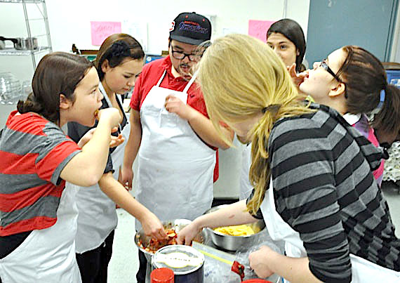 Inuksuk High School students sample homemade salsa that they made during a Skills Nunavut cooking club class. These cooks-in-training can take home their creations, or donate it to a local charity in town, such as Iqaluit’s shelters or the local soup kitchen. (PHOTO BY SARAH ROGERS)