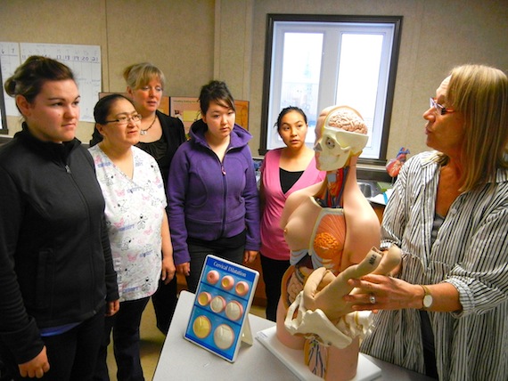Students in Nunavut Arctic College's Cambridge Bay maternal care and midwifery program, Hilary Irwin, Bernice Lyall, Heather Omilgoitok, Shelly O'Gorman and Aimo Nauyuk listen to instructor Elizabeth Hadlari. The students' three-year course will enable them to practice midwifery at Cambridge Bay's Kitikmeot Health Centre. (PHOTO BY JANE GEORGE)