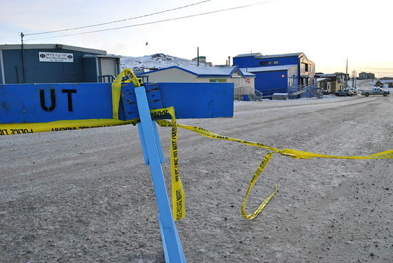 An Iqaluit man is now being treated at Qikiqtani General Hospital for a gunshot wound to the chest, following an incident in south Iqaluit early on Nov. 23. The RCMP say they responded to a complaint about a man firing shots in the 100s area. When police arrived, a man pointed a firearm at them, then fled. Police found the man at house 238, arrested him, and took him to hospital. Police have not named the man. Another man is also being treated in hospital for what police describe as non-life-threatening injuries. Early in the afternoon of Nov. 23, these police barriers on Nipisa Street were taken down. However, a police vehicle remains parked at the back of building 162, in front of a dwelling unit that appears to be a major focus of the police investigation. (PHOTO BY JIM BELL)