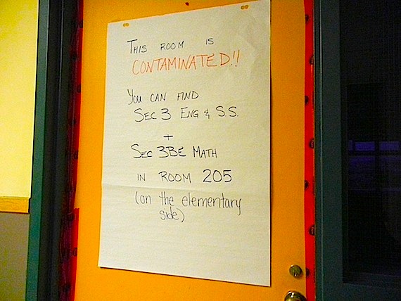 A taped-off classroom door with a sign saying 