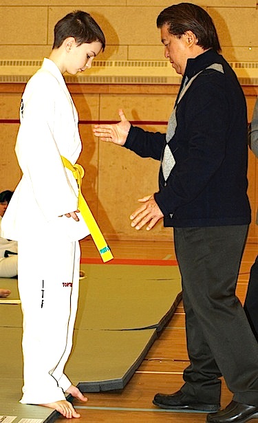 Alexander McDermott is congratulated by taekwondo grand master Phap Lu after receiving his yellow belt with green stripe, while head instructor Don Peters is about to hand him his certificate. Lu came to Iqaluit Dec. 1 to 4 to evaluate students and award sport belts and certificates marking their progress. (PHOTO BY DEAN MORRISON)
